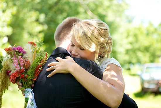 Bride and groom embrace joyfully after wedding ceremony