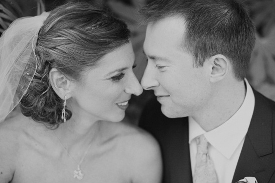 Black and white photo of bride and groom touching noses