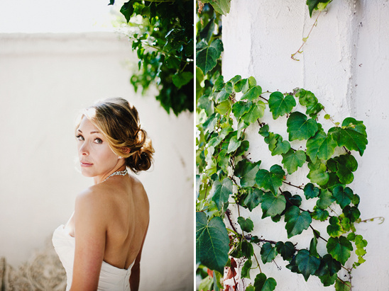 Bride looks back over shoulder at a rustic venue