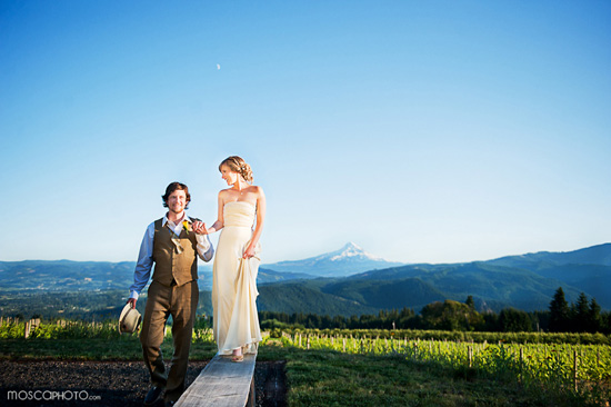 Vineyard wedding couple stroll hand in hand at sunset