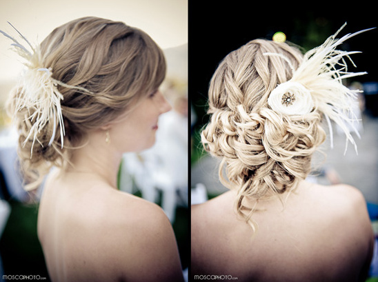 Bridal updo with feather and floral accessory