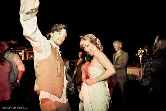 Bride and groom joyfully dancing at their wedding reception