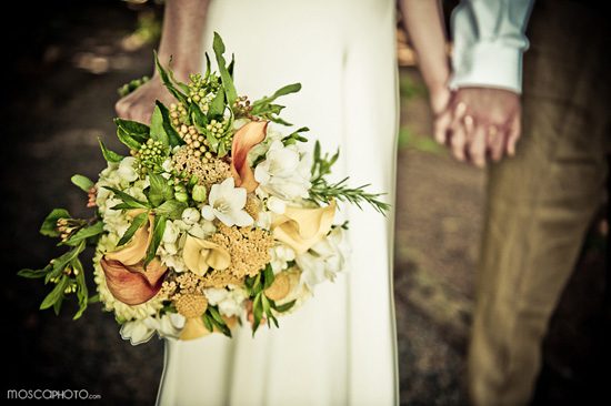 Bride holding elegant wedding bouquet and holding hands