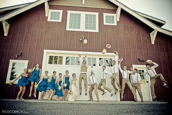 Wedding party jumping at barn wedding venue photo