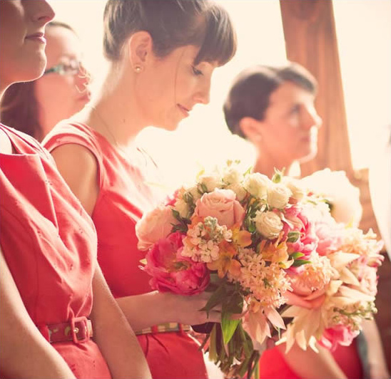 Bridesmaid holding beautiful coral wedding bouquet