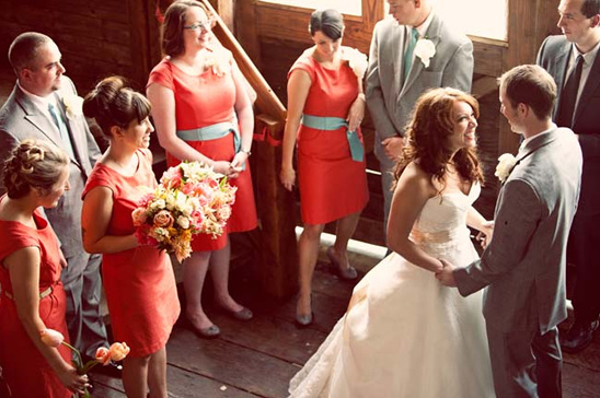 Bride and groom exchanging vows, surrounded by bridesmaids