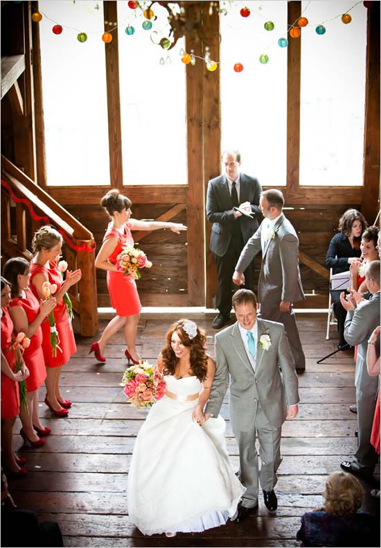 Bride and groom walking down aisle, colorful decor