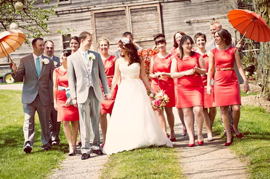 Happy bride and bridesmaids in coral dresses