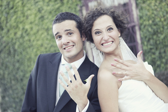 Happy couple showing wedding rings