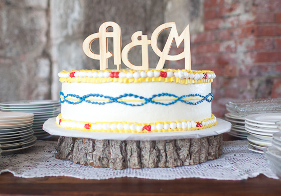Rustic wedding cake with monogram topper and wood stand