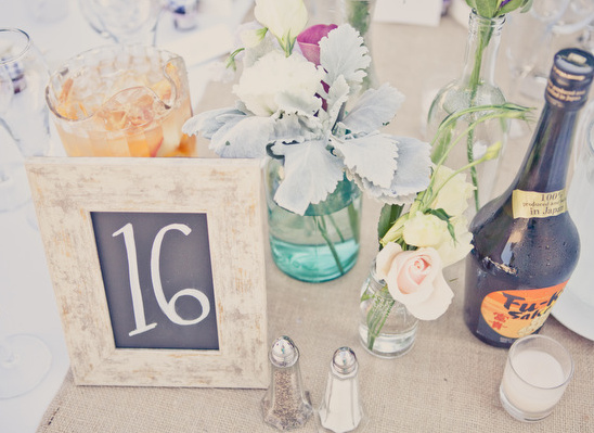 Wedding table number sixteen with flowers and drinks