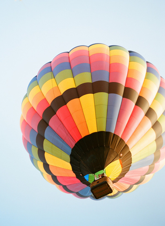 Colorful hot air balloon soaring high in the clear blue sky