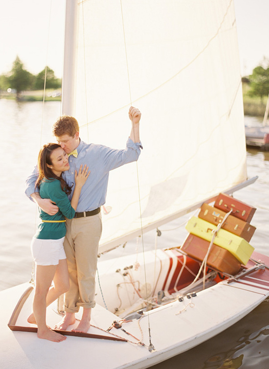 Romantic couple enjoying a sail on a boat, embracing on a sunny day