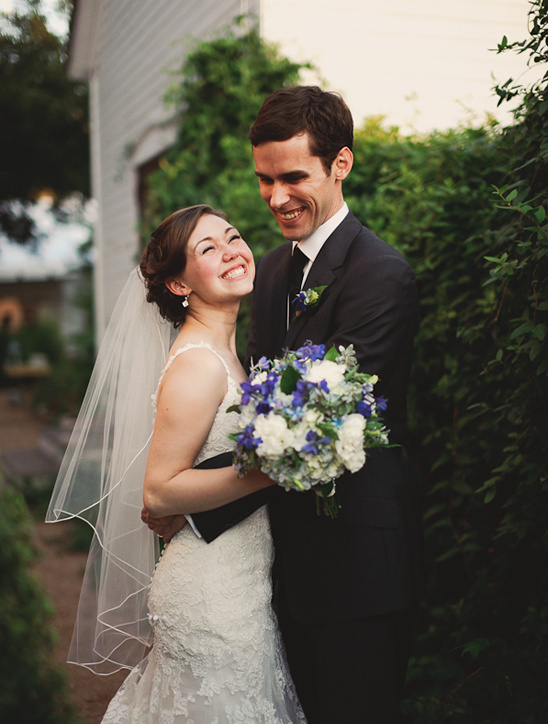 Happy bride and groom smiling together at their wedding