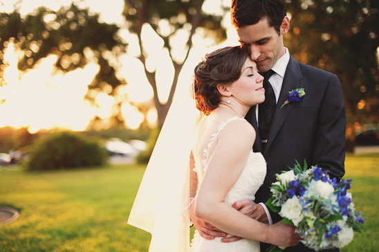 Happy bride and groom embracing on their wedding day outdoors