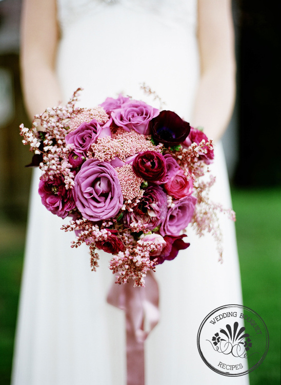 Bride holding a beautiful purple and pink wedding bouquet