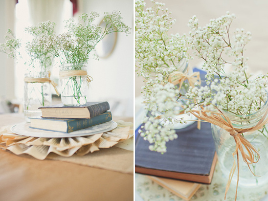 Rustic wedding table setting with baby's breath in jars with books
