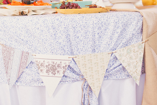 Festive table setting with floral bunting banner and decorations
