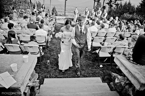 Newlyweds walking down the aisle after a beautiful outdoor wedding