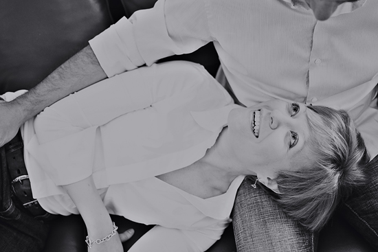 Woman smiles and looks up at the person, in black and white portrait