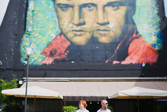 Elvis Presley mural above restaurant with people in foreground