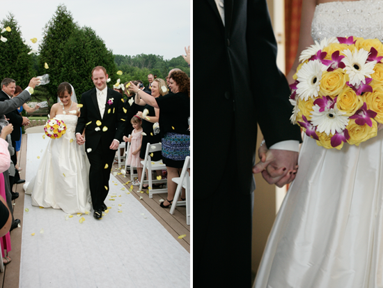 Bride and groom walking down aisle, showered with petals, wedding flowers