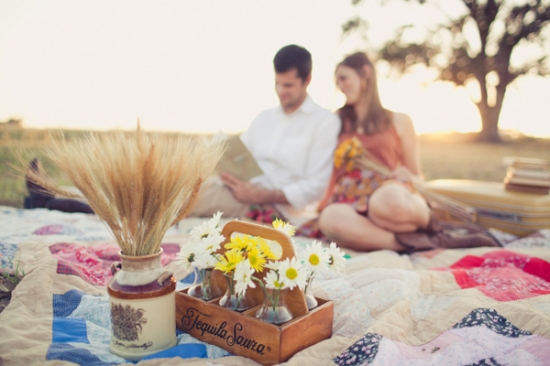 Romantic picnic scene with flowers, couple reading a book