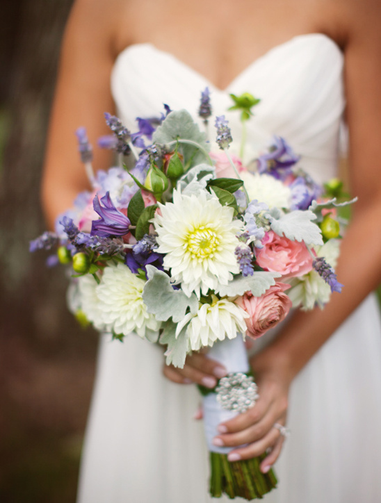 Bride holding a beautiful wedding bouquet of colorful flowers