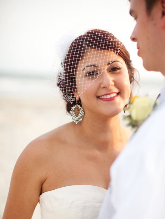 Happy bride smiles at her groom on their wedding day