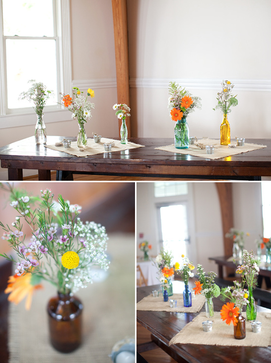Rustic wedding table decor with colorful wildflowers in vases