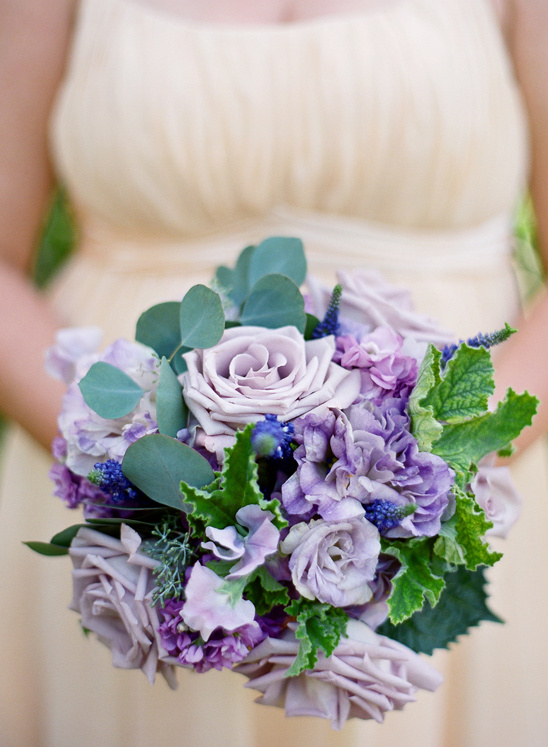Bride holding a bouquet of soft purple and green flowers