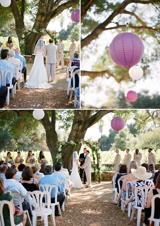 Outdoor wedding ceremony with floral arch and purple lanterns