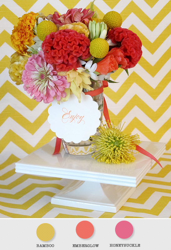 Colorful floral bouquet on a white stand with a chevron background