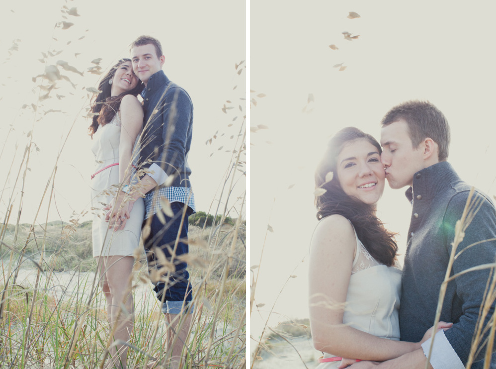 Romantic couple holding hands in a field, kiss on cheek