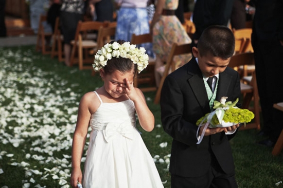 Flower girl crying at a wedding, boy carrying ring pillow