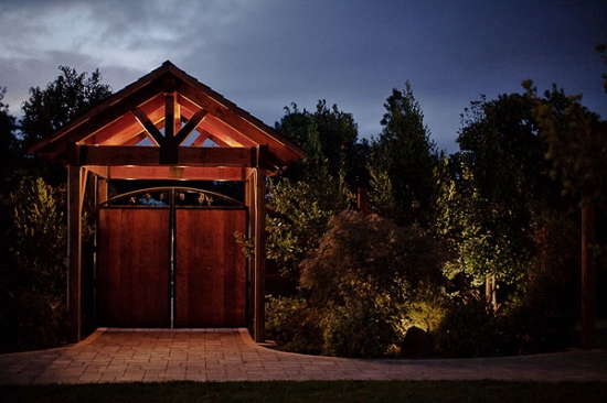 Wooden garden gate at night with warm lighting