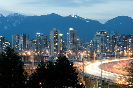 City skyline at dusk with mountain backdrop and long exposure