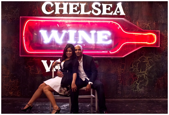 Couple at Chelsea Wine Bar, posing in front of neon sign