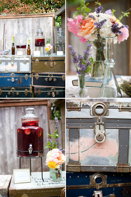 Rustic wedding drinks and floral arrangements on vintage suitcases