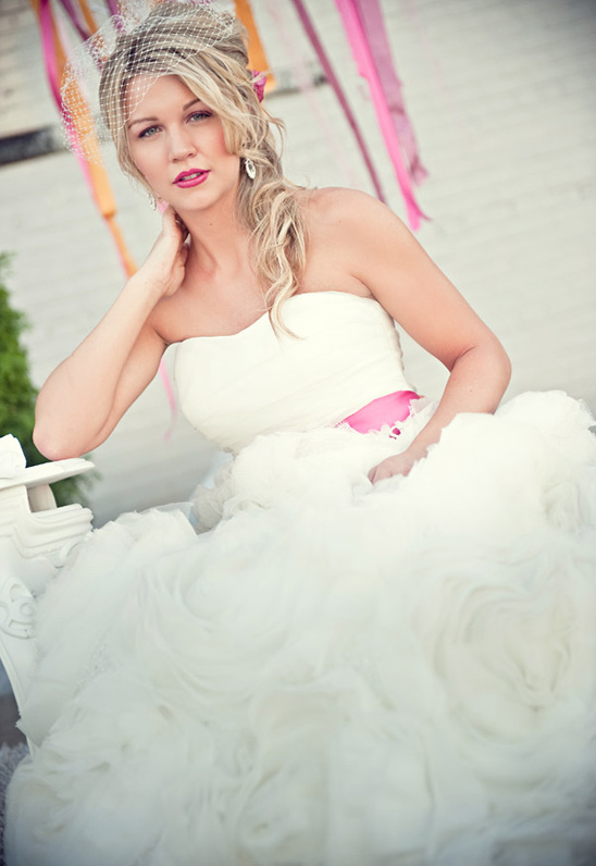 Elegant bride in a flowing white wedding dress posing for photos