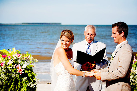 Happy couple exchanging vows at a beach wedding ceremony