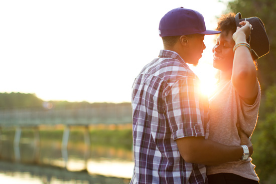 Romantic couple embracing during a beautiful sunset at the park
