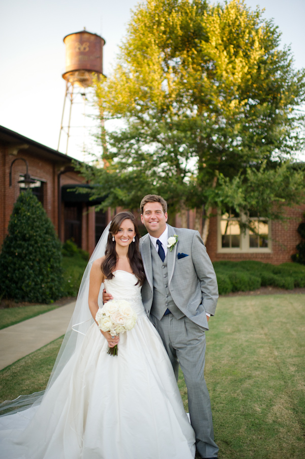 Happy couple on their wedding day with a stunning outdoor backdrop