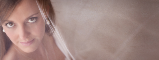Beautiful woman gazing through a veil, soft focus portrait