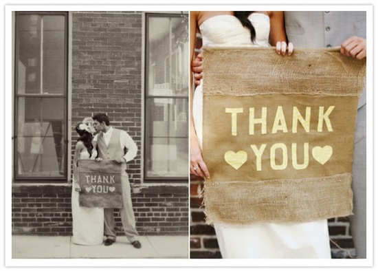 Bride and groom holding a Thank You sign, rustic wedding style