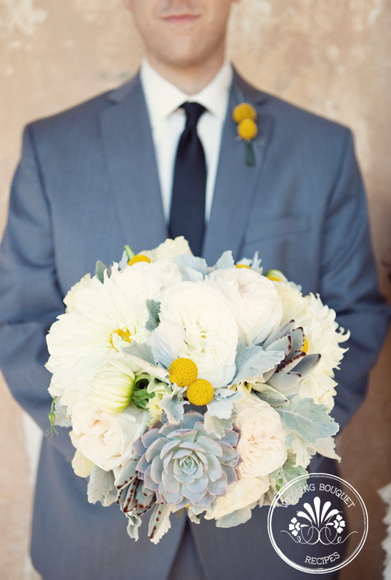 Groom in gray suit holding a beautiful white wedding bouquet
