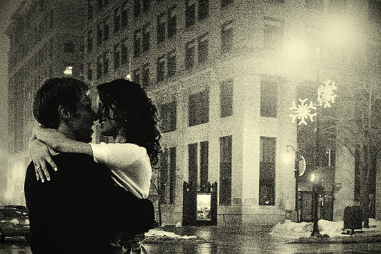 Romantic embrace in the city during winter with bokeh lights