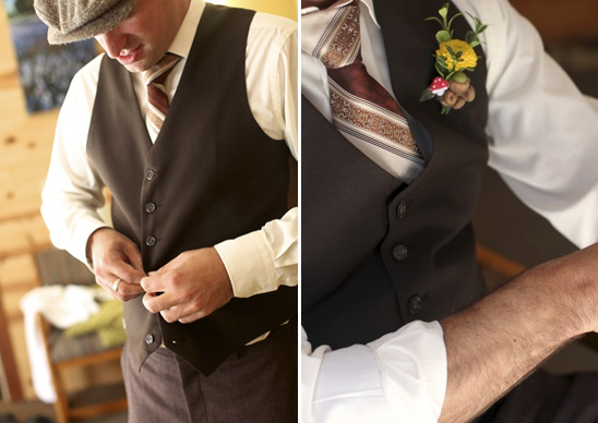 Man in brown vest buttoning shirt