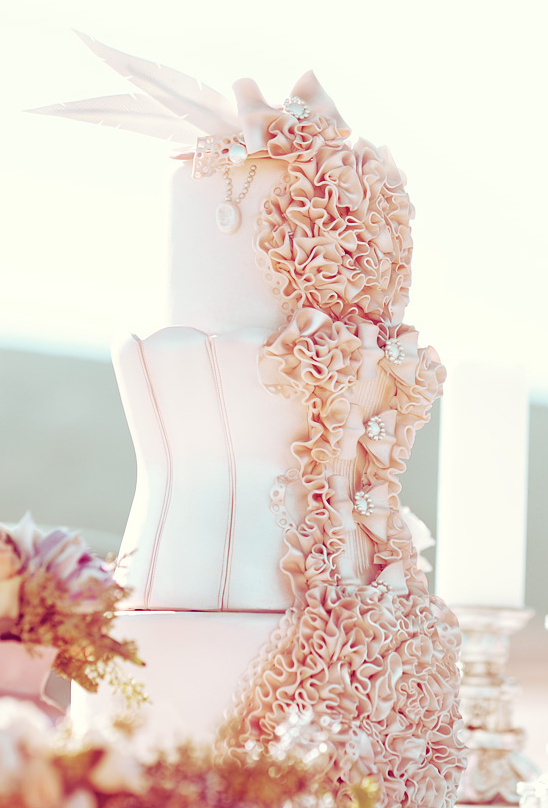 Elegant peach wedding cake with ruffled frosting detail