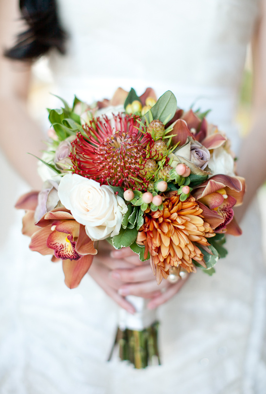 Bridal bouquet of orchids roses and pincushion flowers